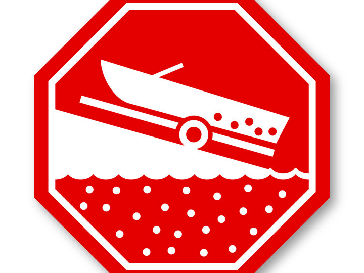 Boat launching down a ramp into water, shown in a red octagonal graphic.